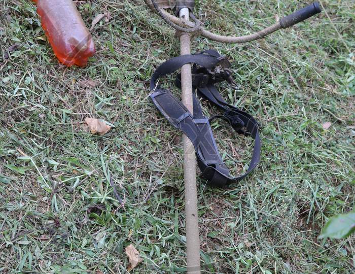 Weed Cutter Powered By Gasoline Kept In Ground After Work