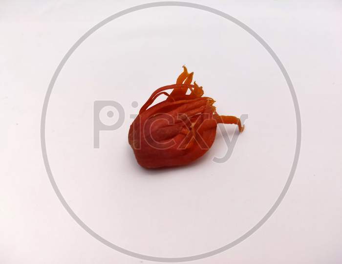 Deep red mace spices isolated in white background.