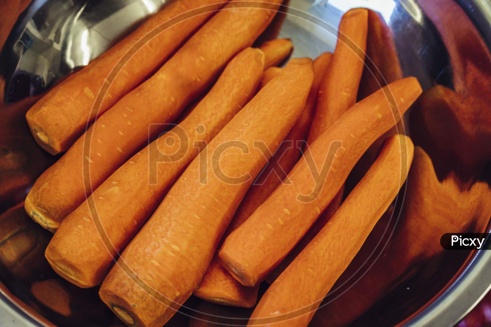 Fresh Peeled Carrots In Stainless Steel Bowl, Isolated Close Up View
