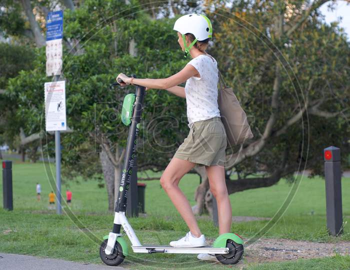 Woman Riding An E-Scooter