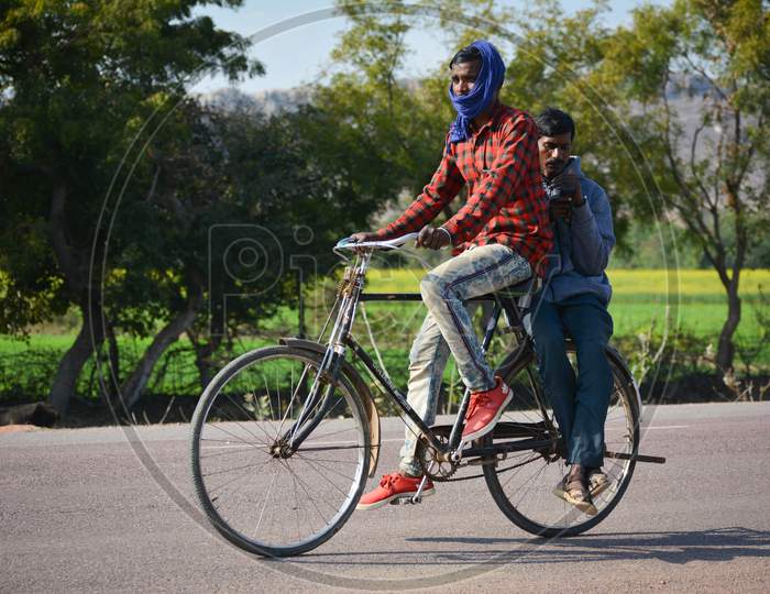 TIKAMGARH, MADHYA PRADESH, INDIA - JANUARY 28, 2020: Two men riding on cycle at outdoor.