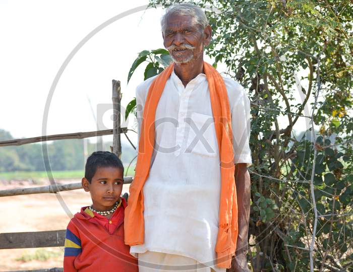 TIKAMGARH, MADHYA PRADESH, INDIA - FEBRUARY 03, 2020: Indian rural old man with grand son.