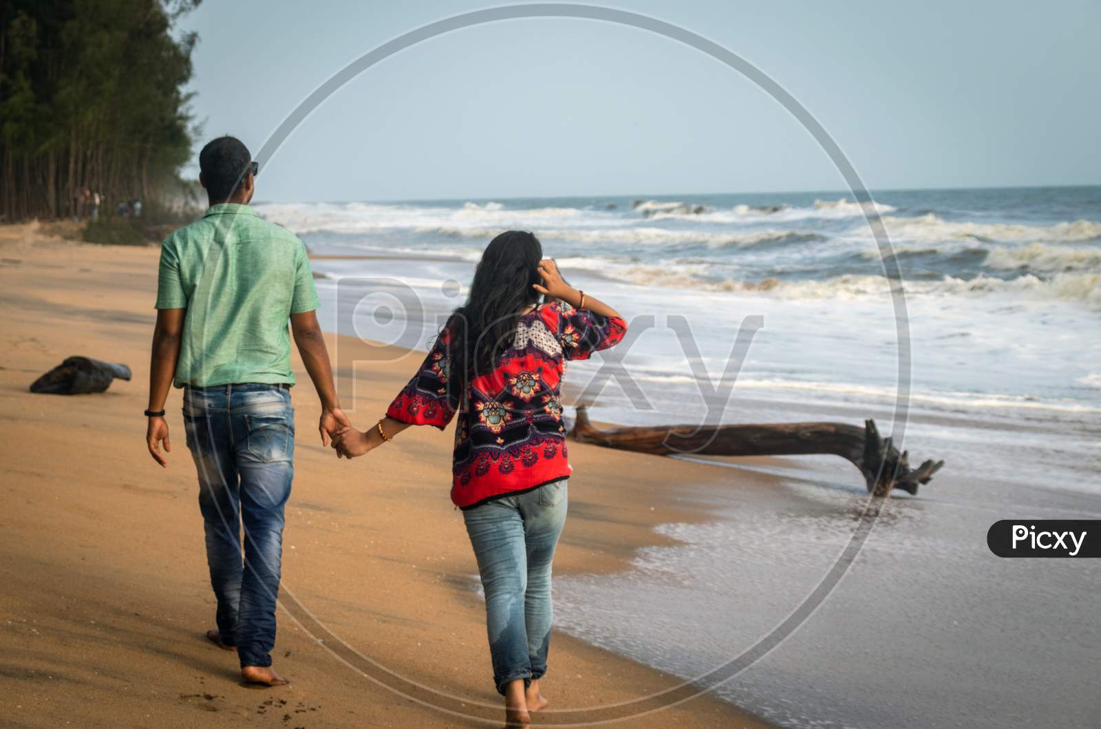 Couple Walking On Sandy Beach With Holding Each Others Hand And Soaking Up The Natural Sea View Image Is Taken At Kochi Kerala India Showing The Love And Affection Of The Couple In The True Nature.