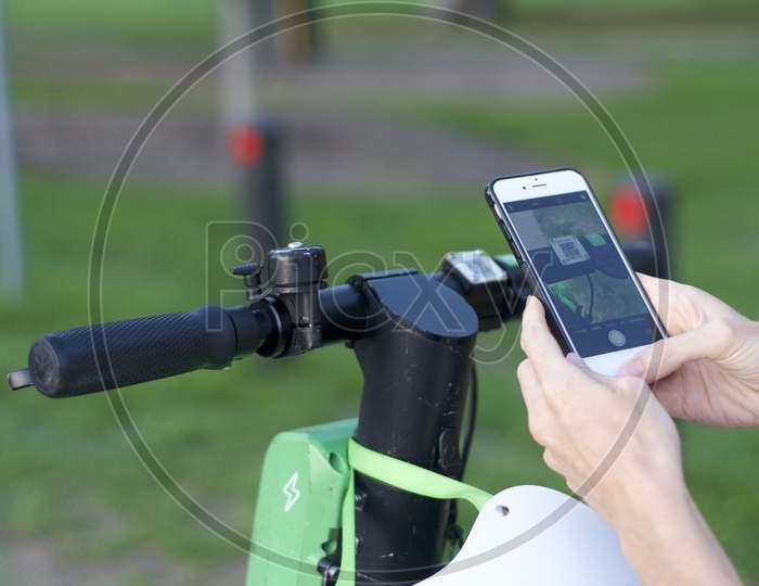 Lime E-Scooter Handlebar And Mobile Phone Ready For Scan