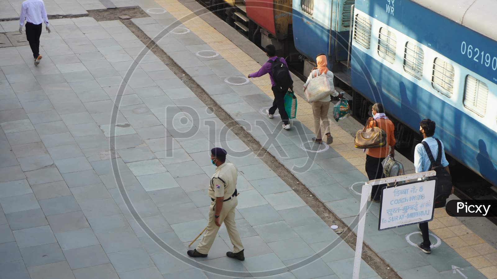MIGRANT WORKERS. Indian migrant workers during COVID 19 Corona Virus nationwide lockdown returning back home special trains Bus Railway station. Police on duty.