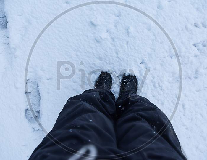 Man Man Standing On Fresh Snow In Hiking Boots Looking Down, Pov - Image