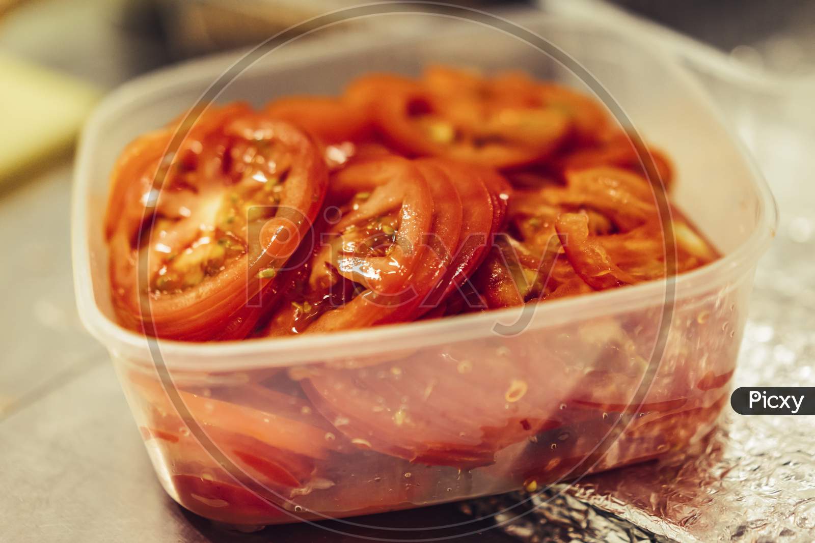 Fresh Juicy Sliced Red Tomatoes In White Plastic Container, Selective Focus Close Up