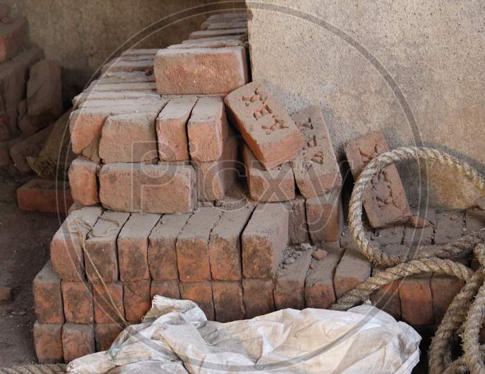 Heap of bricks and a rope at a construction site