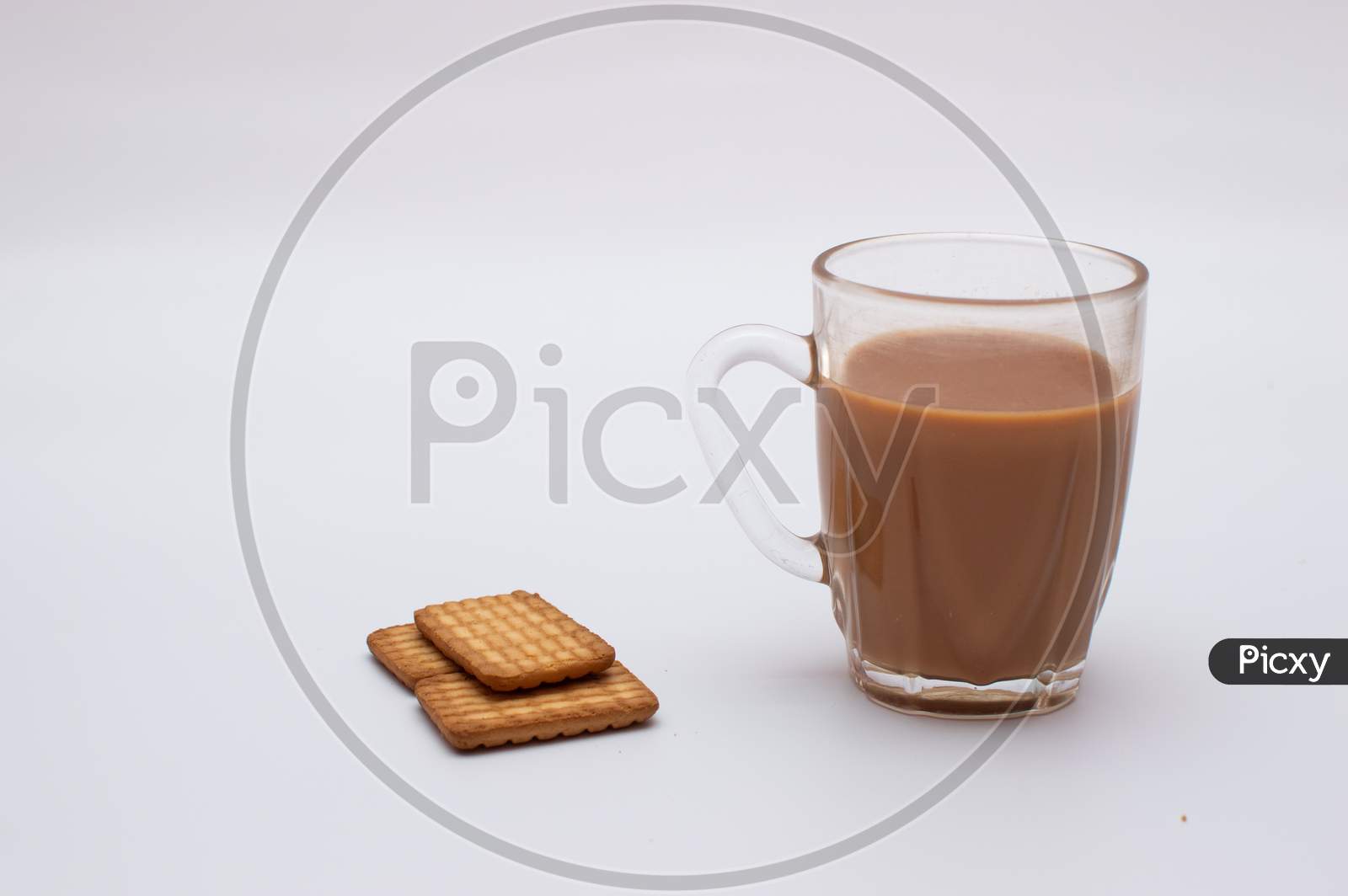 Cup of tea and three biscuits on white sheet