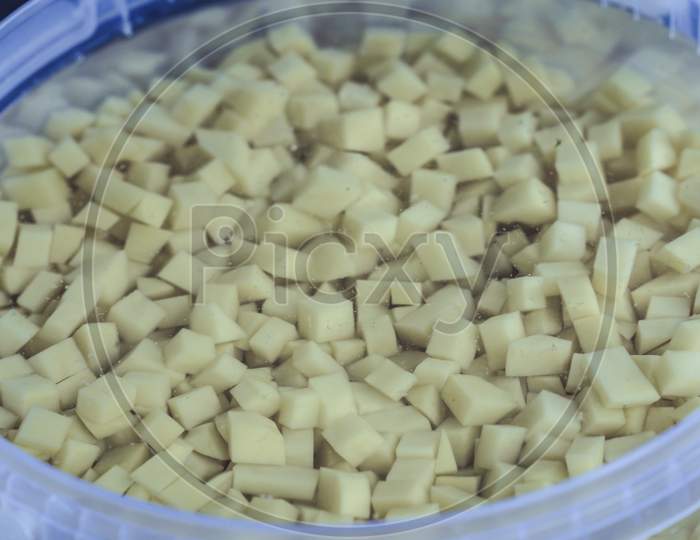 Chopped Potato Pieces In Bowl In Water