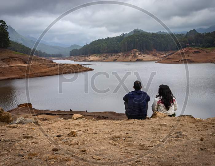 Couple Thinking And Feeling The True Nature At Lakeside