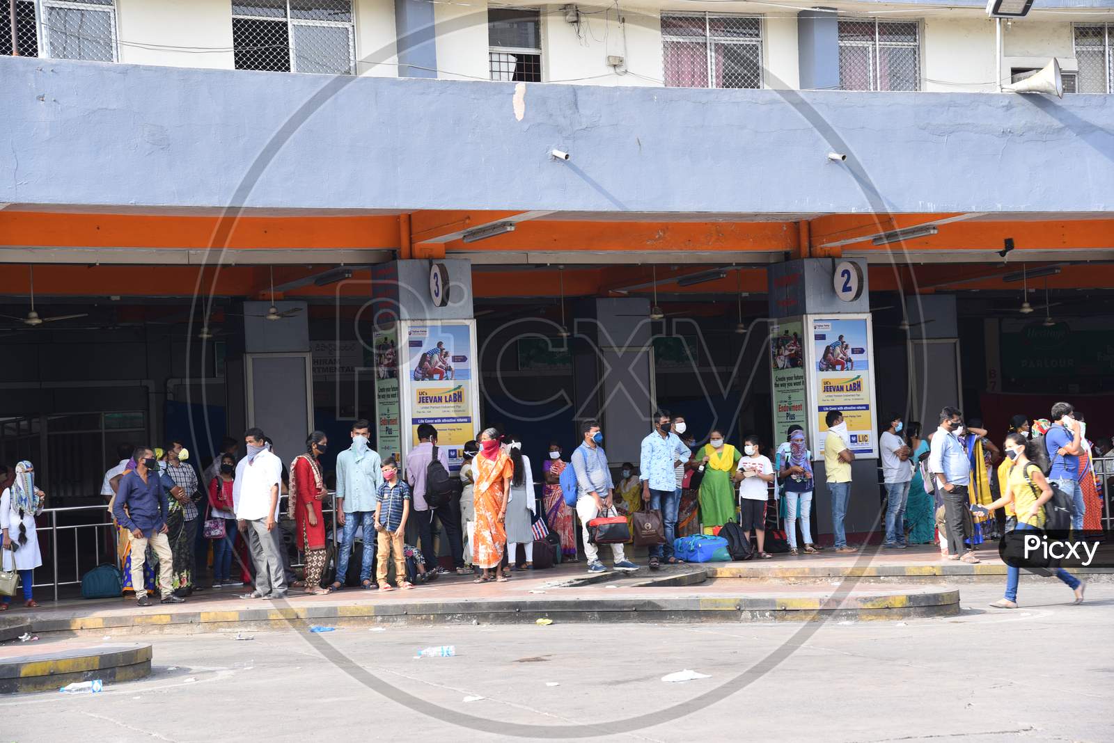People wait for Inter District TSRTC Buses at Jubilee Bus Station amid travel relaxations announced by Telangana State Government, May 24, 2020