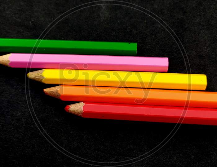 some colorful wooden pencil isolated on black background