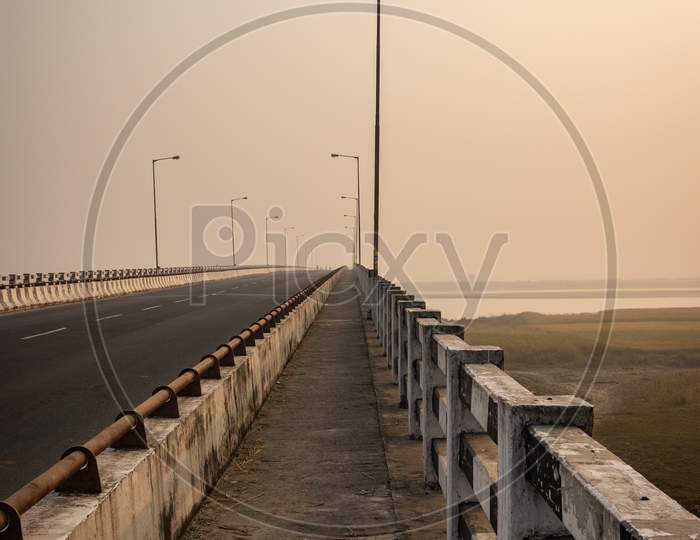 Road Bridge Over River At Dawn From Flat Angle