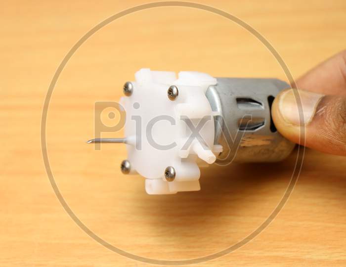 Dc Motor Powered Small Water Pump With Small Tubes Held In Hand