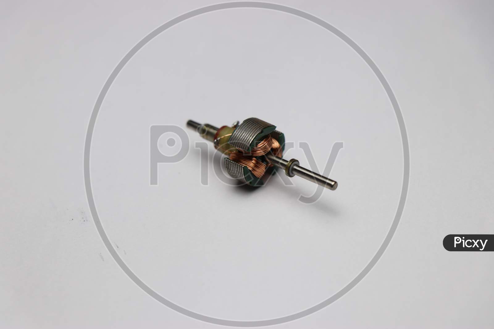 Rotating Part Of Dc Motor With Shaft And Copper Windings On White Background