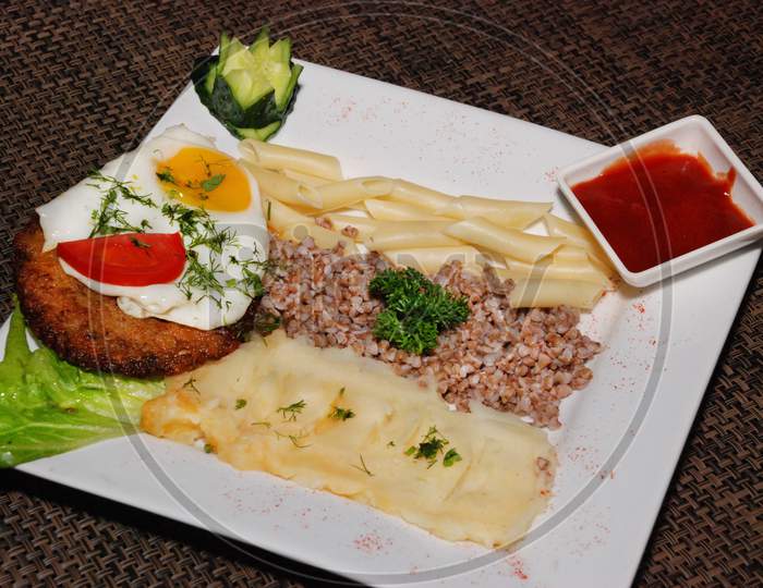 Fried Egg With Cutlet And Garnish