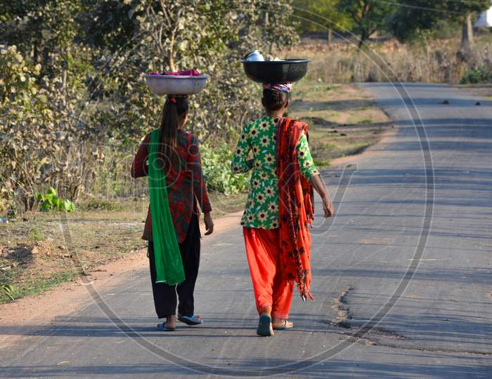 Two girls walking on the street, An Indian rural scene.