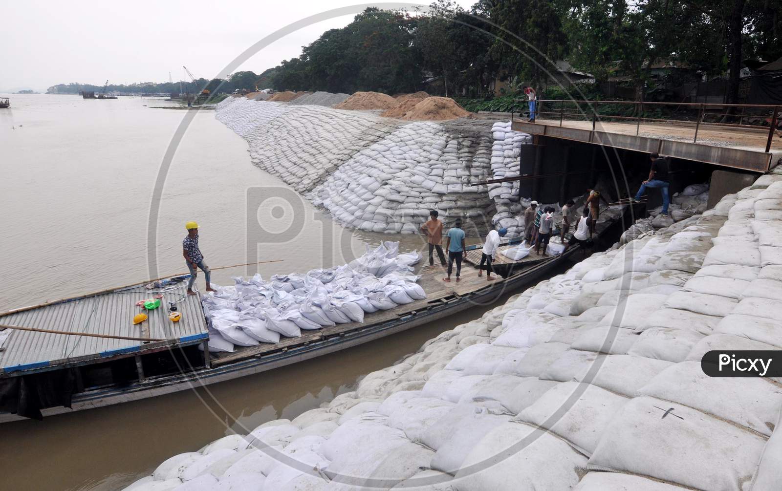 Workers Construct An Embankment Using Sandbags  To Prevent Erosion Along The Banks Of River Brahmaputra Ahead Of The Monsoon Season, In Guwahati, Sunday, May 24, 2020.