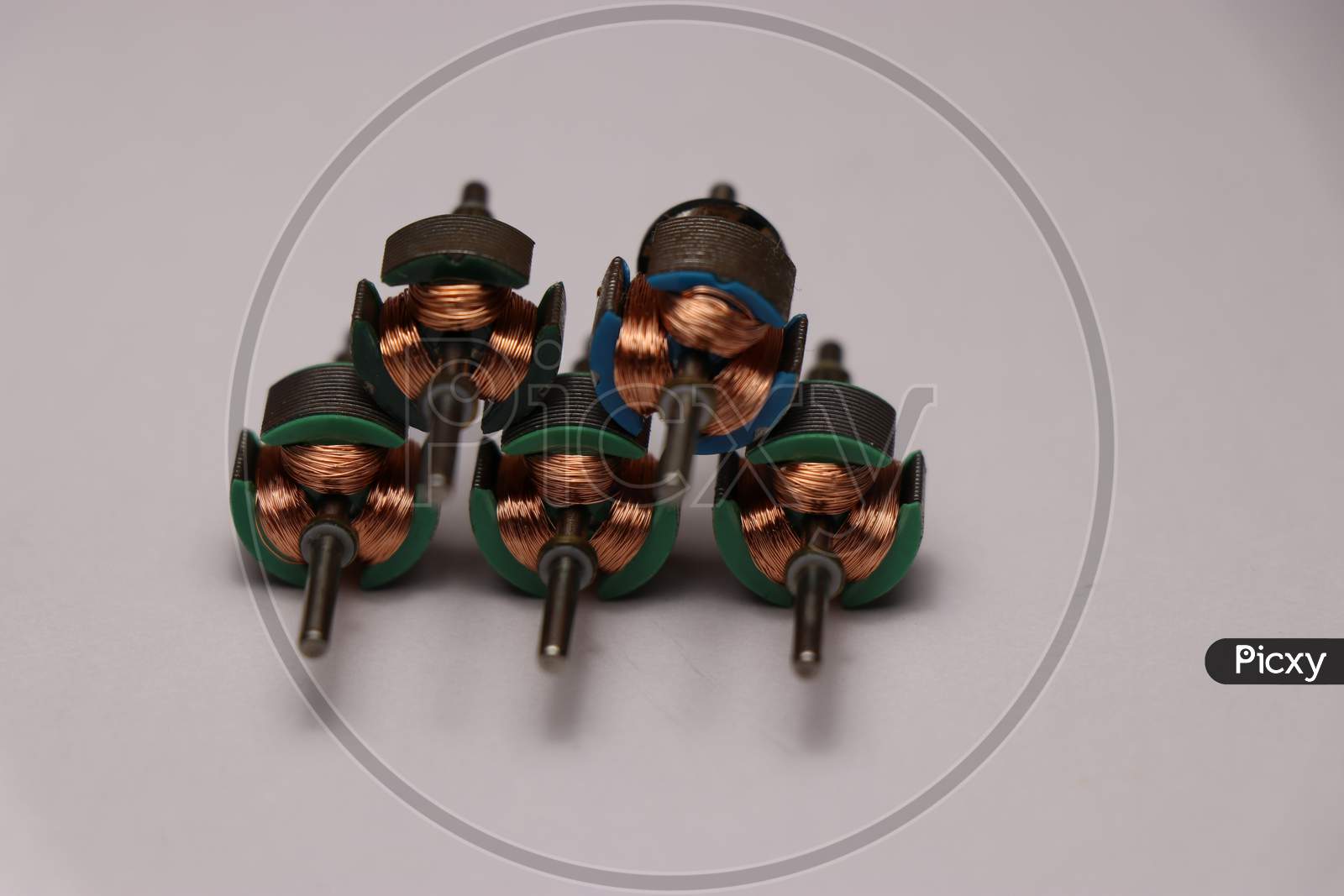 Rotors Set From Dc Motor With Shaft And Copper Windings On White Background