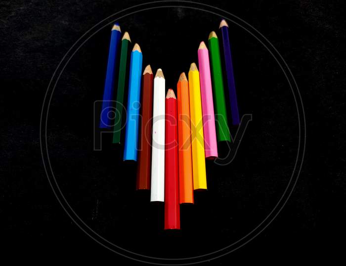 some colorful wooden pencil isolated on black background