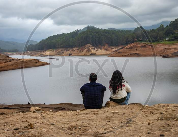 Couple Thinking And Feeling The True Nature At Lakeside