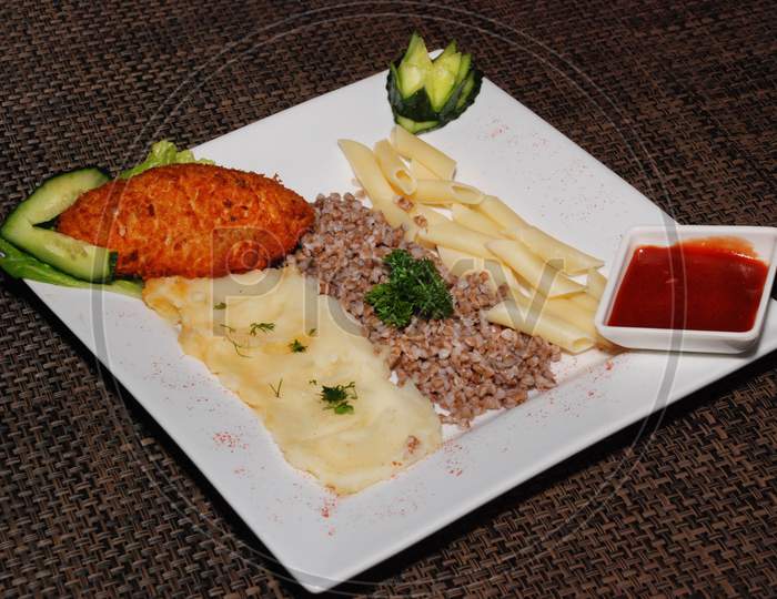 Cutlet Kievsky And Garnish On The White Plate