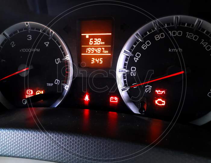 Closeup Of Glowing Digital Dashboard Of A Car At Night Indicating Speed, Fuel, Temperature, Power
