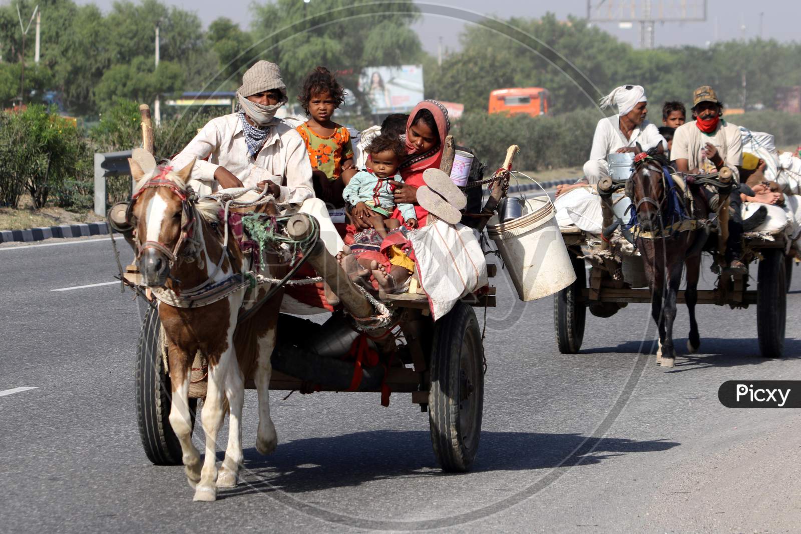Migrant Families Travelling On Horse Carts To Their Native Places On Jaipur-Ajmer National Highway During Extended Nationwide Lockdown Amidst Coronavirus Or COVID-19 Pandemic in Jaipur On May 21, 2020