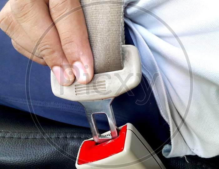 A Male Person Wearing Seat Belt While Driving Safe And Knows Driving Rules