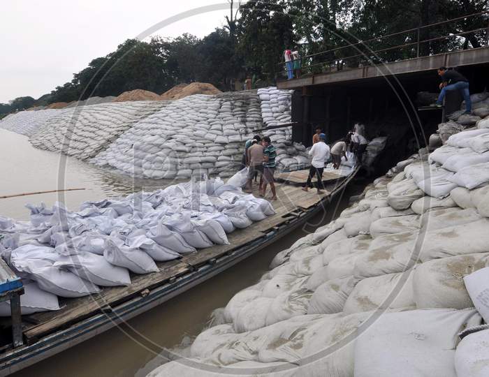 Workers Construct An Embankment Using Sandbags  To Prevent Erosion Along The Banks Of River Brahmaputra Ahead Of The Monsoon Season, In Guwahati, Sunday, May 24, 2020.