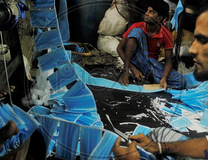 Workers make protective masks inside a workshop in Mumbai, India, March 14, 2020.