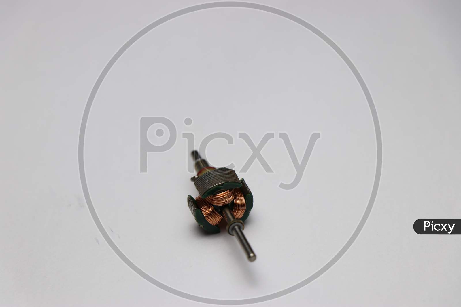 Dc Motor Rotor Part With Shaft And Copper Windings On White Background