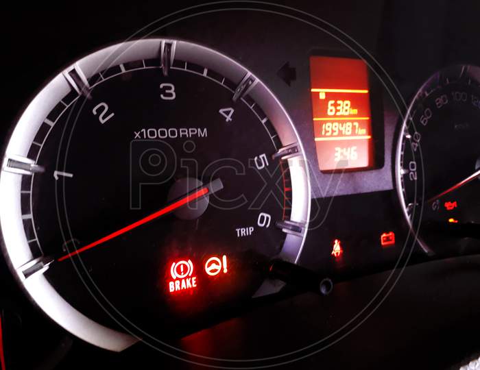 Closeup Of Glowing Digital Dashboard Of A Car At Night Indicating Speed, Fuel, Temperature, Power