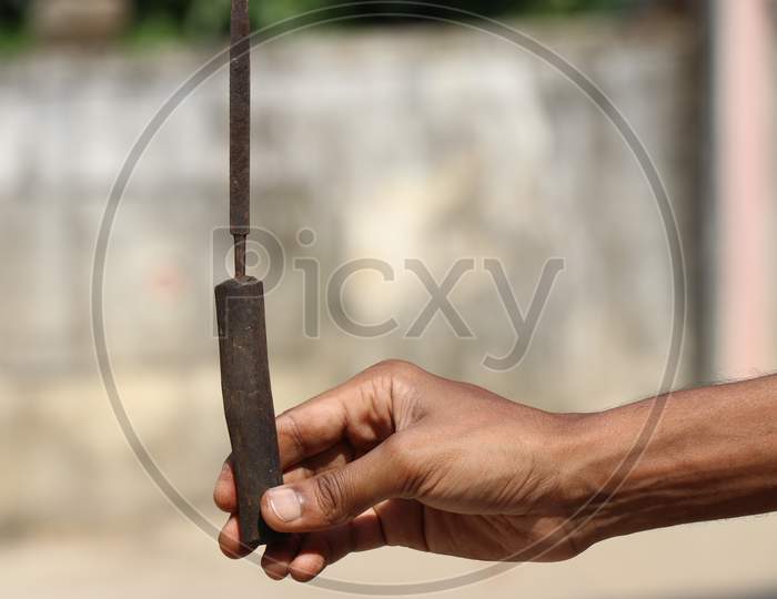 Knife Sharpening Tool With Wooden Handle Held In Hand