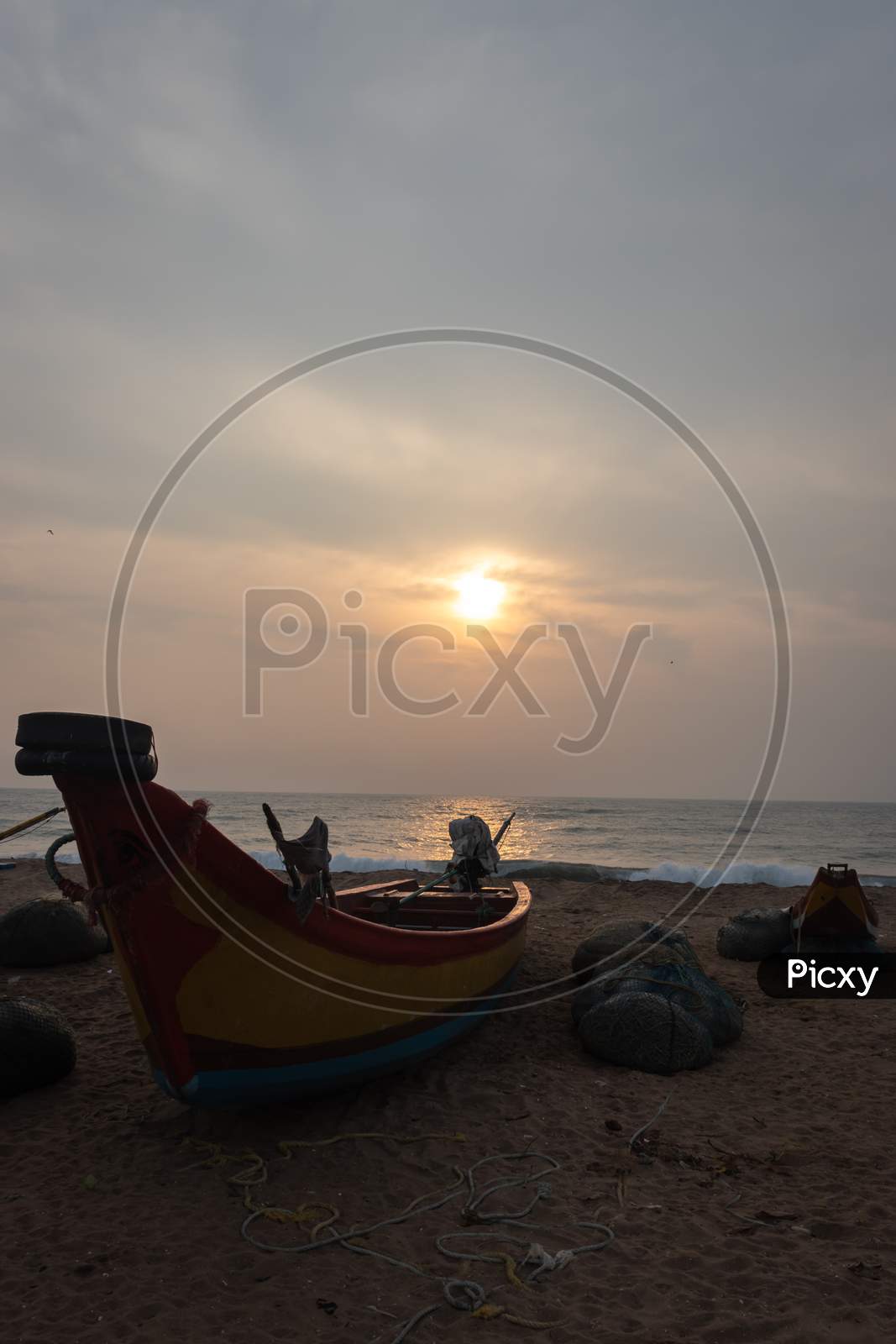 Fishermen Boat On Sandy Beach At Sunrise