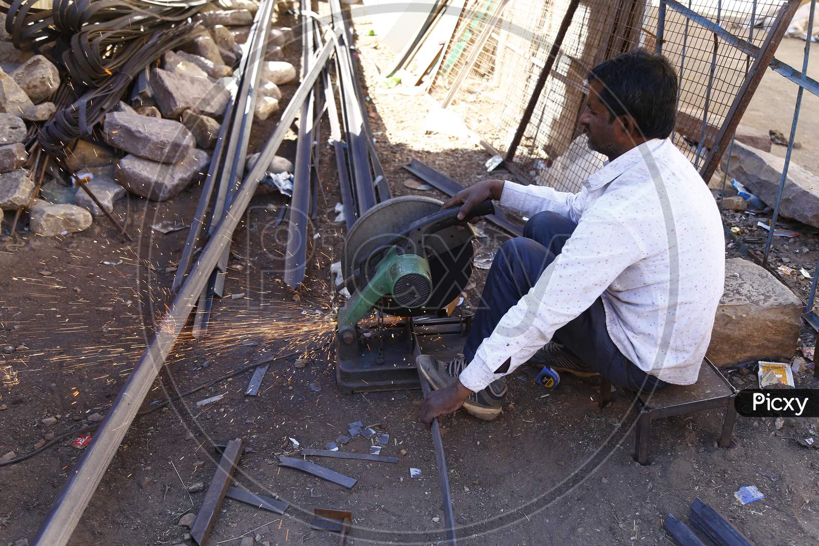 A Worker Cutting Iron Bars With a Machine in Jaisalmer ,Rajasthan, India