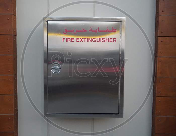Container With A Fire Extinguisher. Wall Mounted Emergency Steel Metal Storage Box On A Wall.