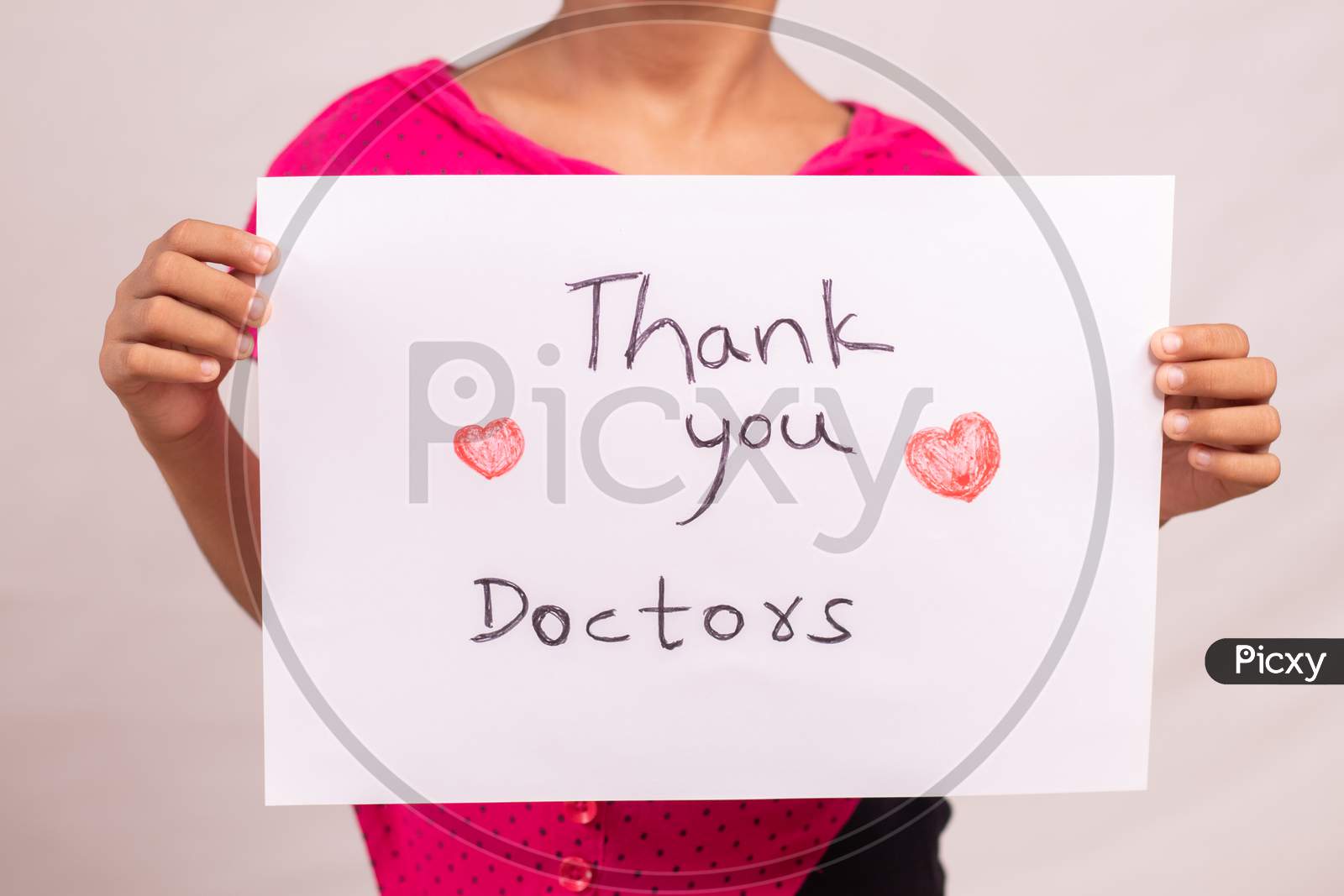 Kid Holding Thankful Greetings To The Doctors And Medical Frontliners Signage, Who Working During Coronavirus Or Covid-19 Pandemic