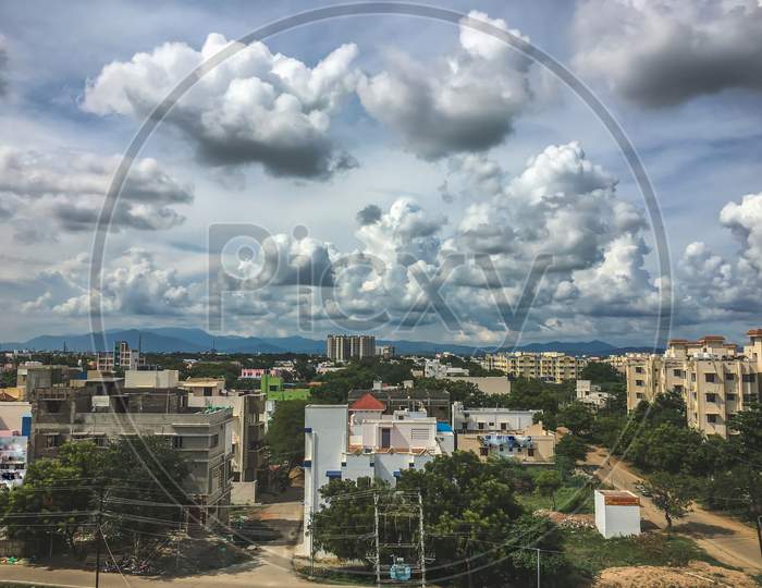 Aerial View Of Chennai Near Tambaram With Background Mountain And Full Of Clouds On Blue Sky. Bird View Over City Of Chennai, India. Indian Urban City On Aerial View Landscape.