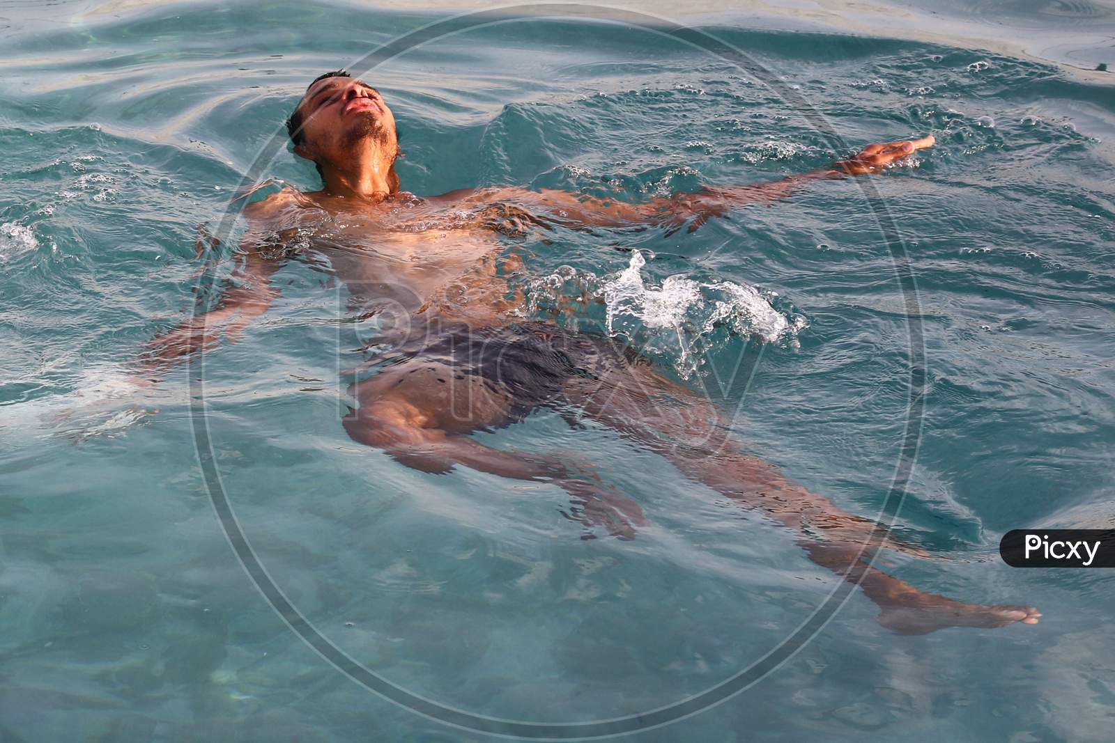 An Indian Man Cools Off Inside a Swimming Pool On A Hot Summer Day In Ajmer, Rajasthan, India On 24 May 2020.