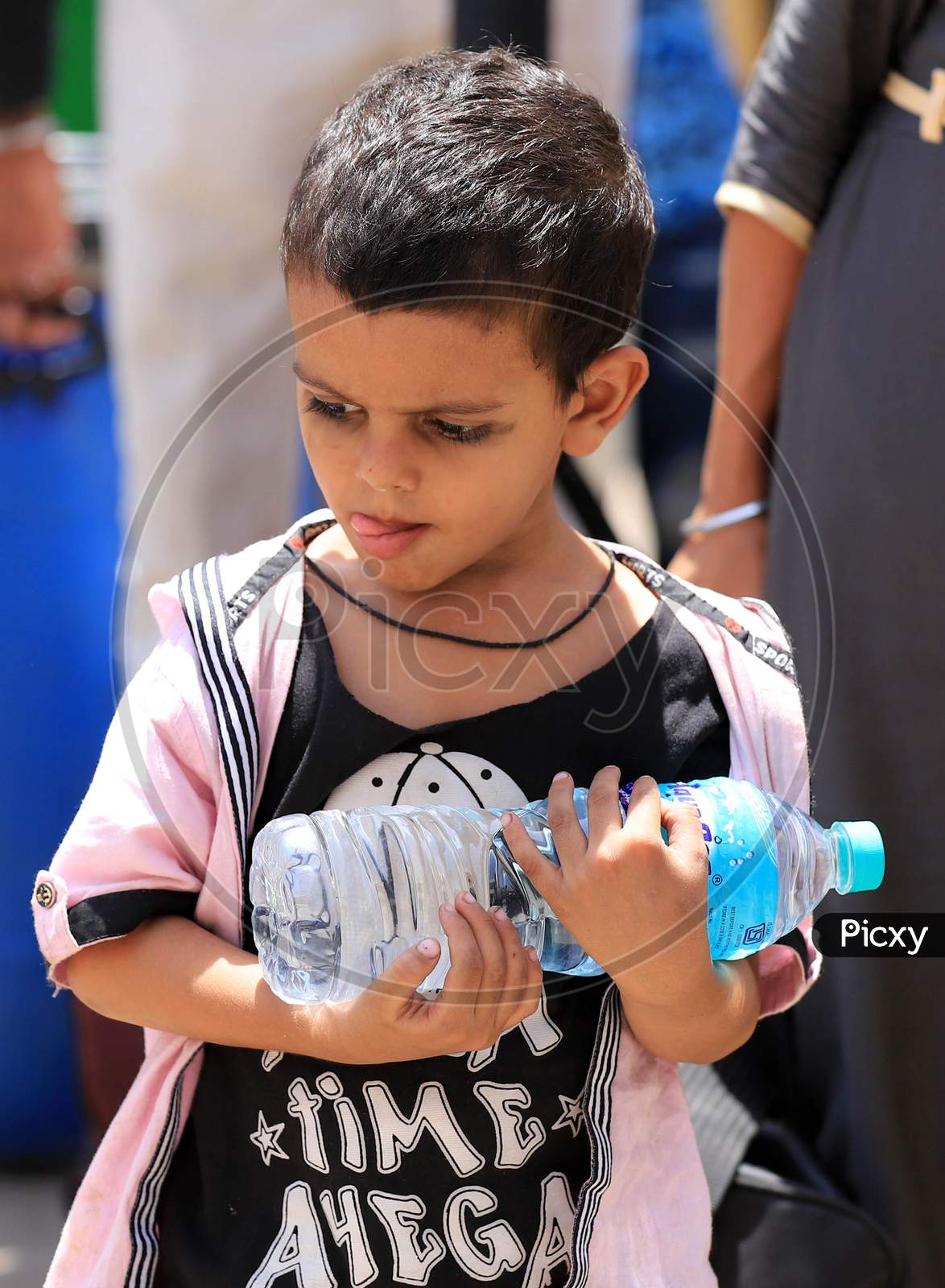 A Girl Holds a Water Bottle On A Hot Summer Day During Extended Nationwide Lockdown Amidst Coronavirus Or COVID-19 Pandemic In Prayagraj, May 25, 2020.