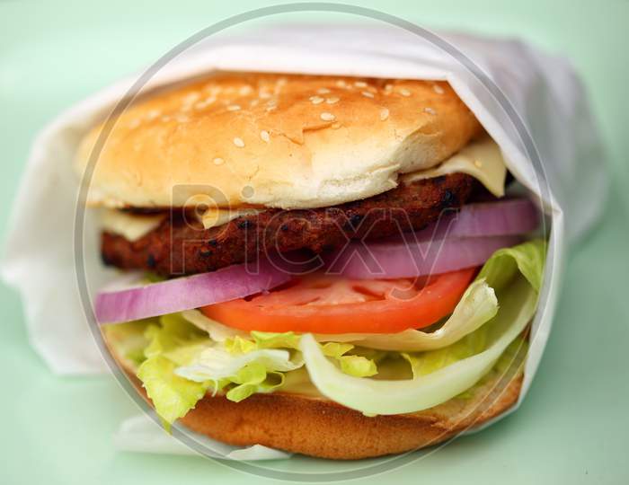 Fresh Delicious Veg burger grilled with tomato, onion, vegetables for healthy breakfast