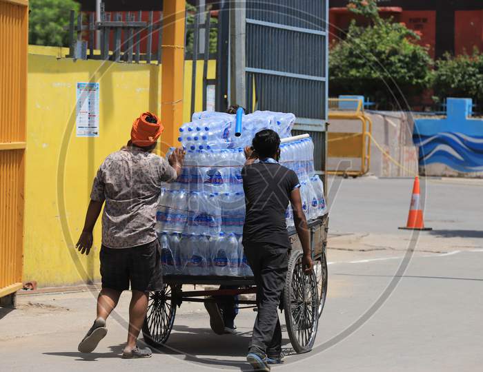 Vendors Transport Water Bottles On A Trolley On A Hot Summer Day During Extended Nationwide Lockdown Amidst Coronavirus Or COVID-19 Pandemic In Prayagraj, May 25, 2020.