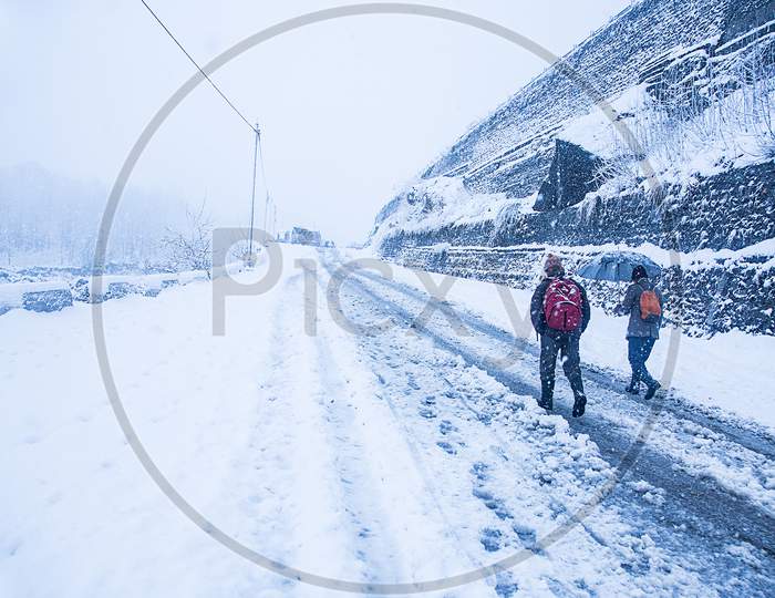 Two Guys Walking At Heavy Snowy Day In The Himachal. Snowfall Winter Concept, Wide Angle Shot - Image