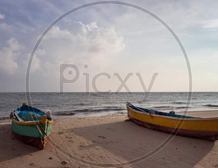 Fishing Boat Isolated On The Sandy Beach With Amazing Sky