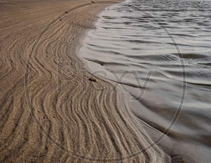 Natural Pattern Made By Sea Waves On Sandy Beach