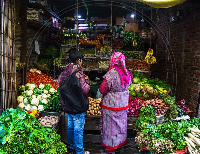 Indian Man And Woman Buying Vegetables On Stall At The Market - Image
