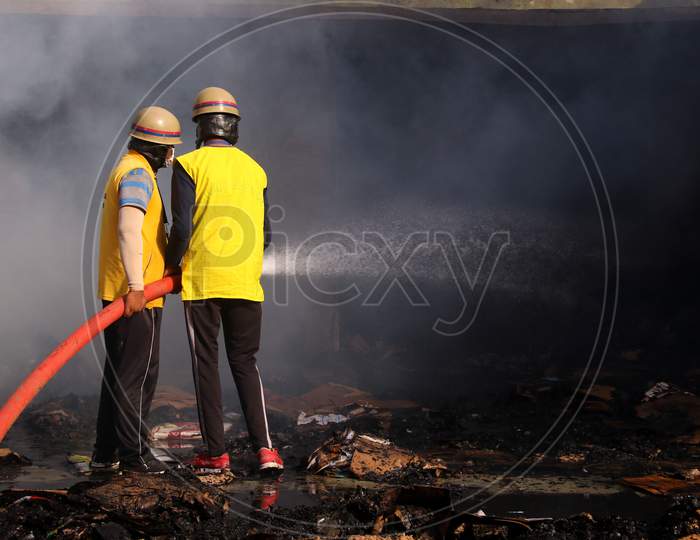 A Firefighter Sprays Water To Control A Fire Broke Out At A Grain Market In Ajmer, Rajasthan, India On 24 May 2020.
