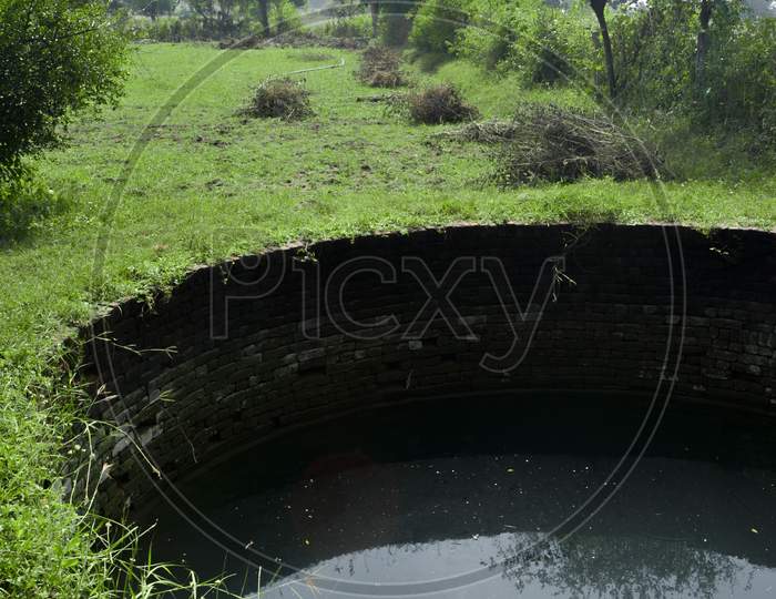 An old water well in a village, rural scenery